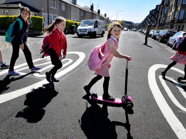 Image showing young children crossing the road on foot and on scooters
